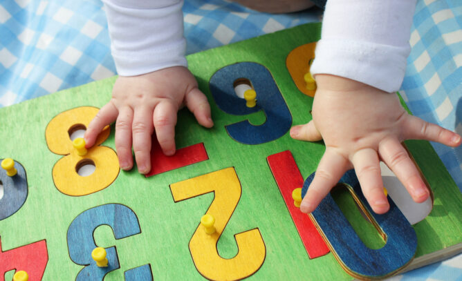 A child’s hands engaging with toys during play