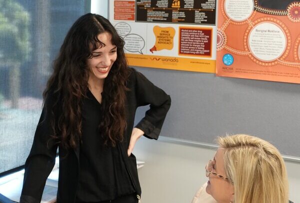Two staff members chat in an office